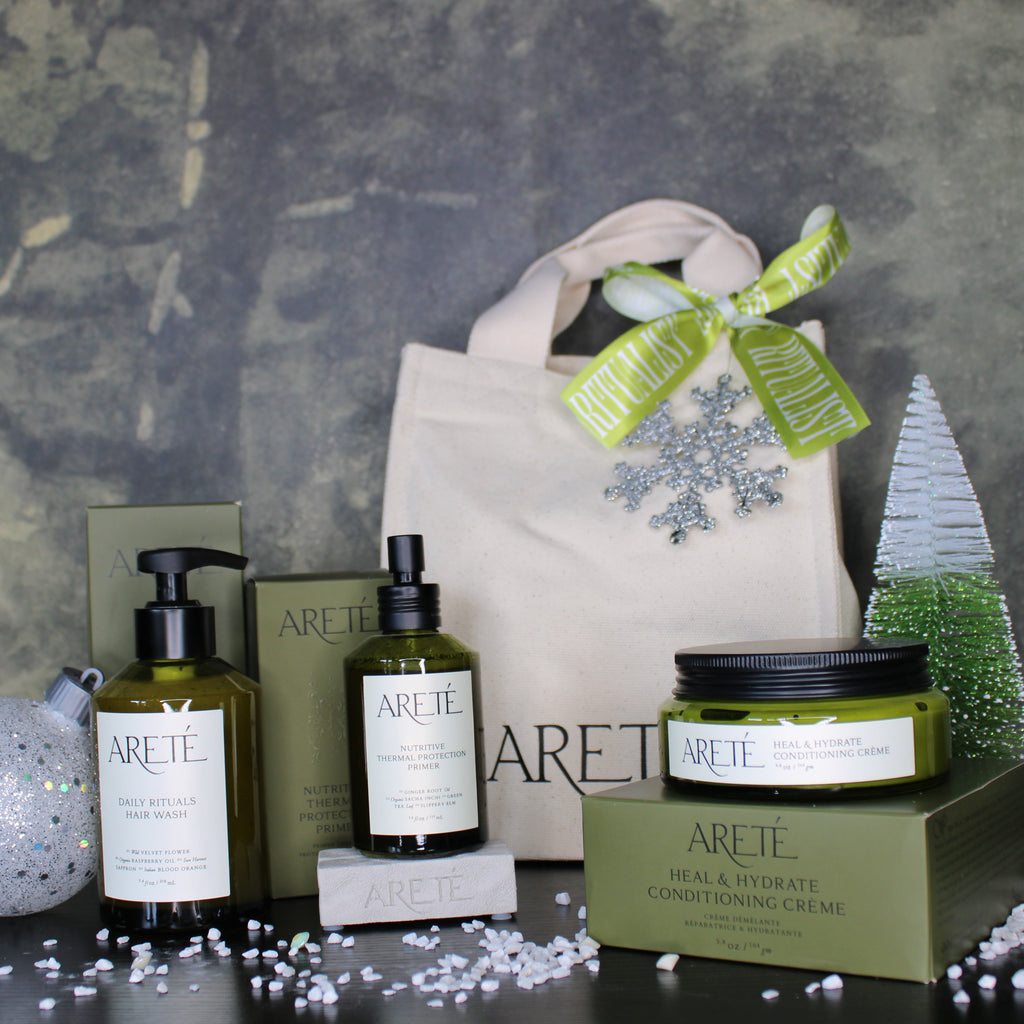 Arette skincare products with a decorative bag and Christmas tree on a textured surface.