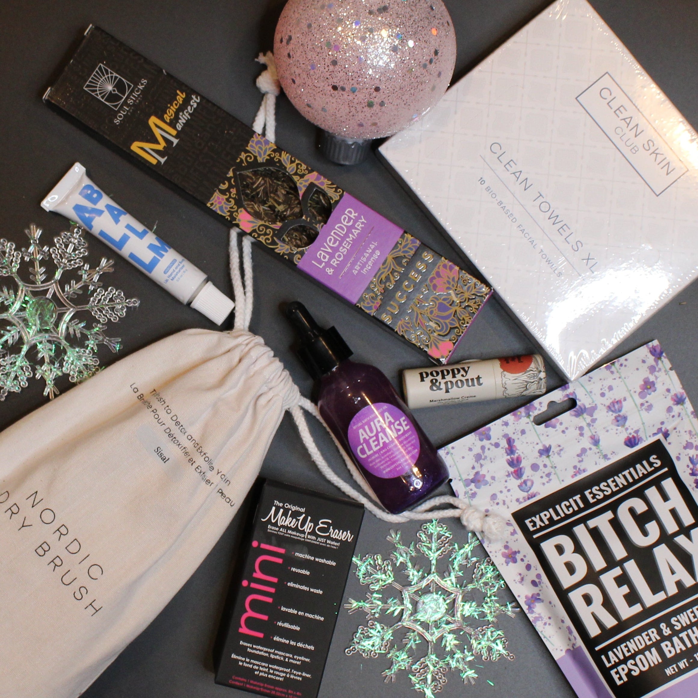 Collection of beauty and wellness products on a dark surface