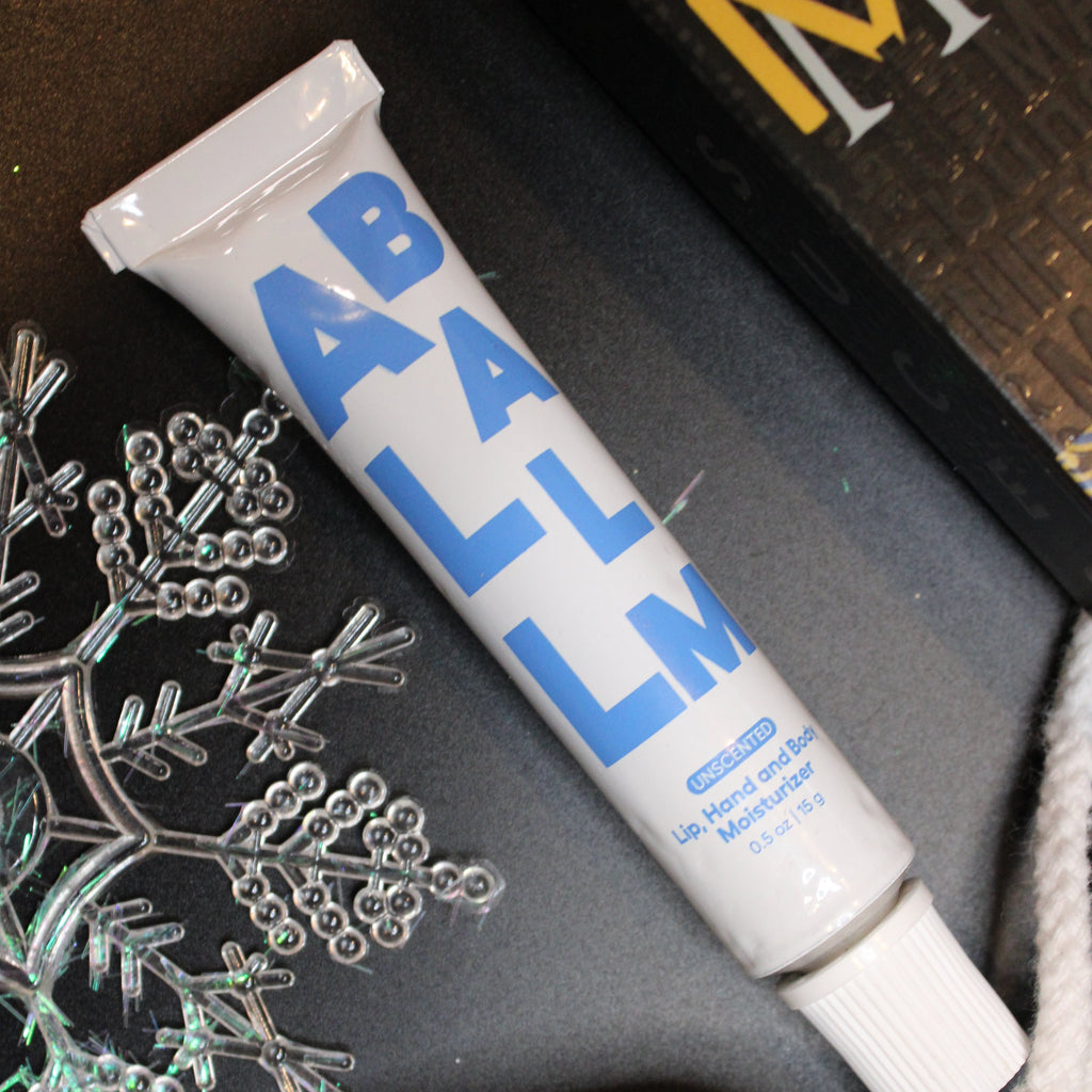 Tube of La Roche-Posay on a dark surface with decorative elements