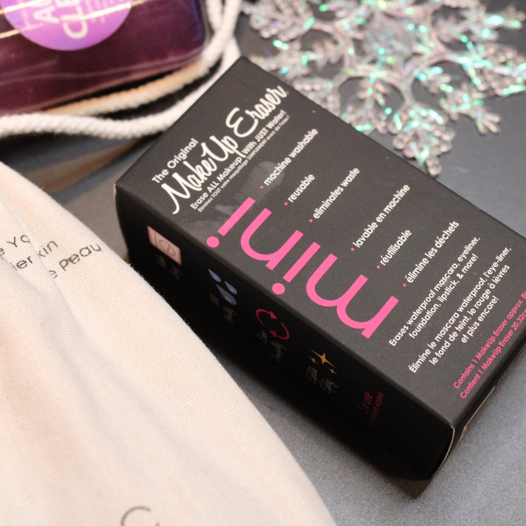 Black makeup remover device with 'minim' branding on a gray surface.