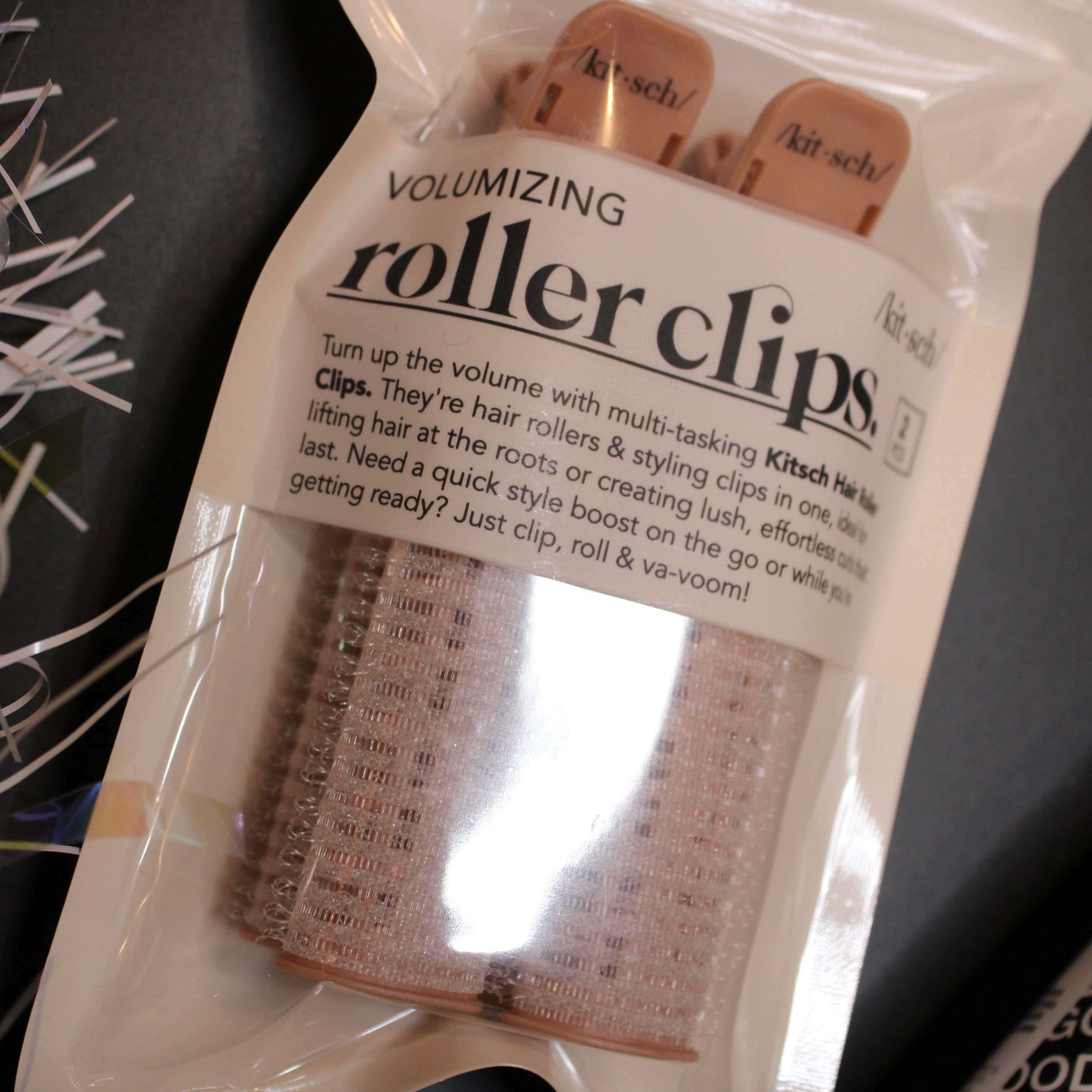 Packaged roller clips with text on a dark background