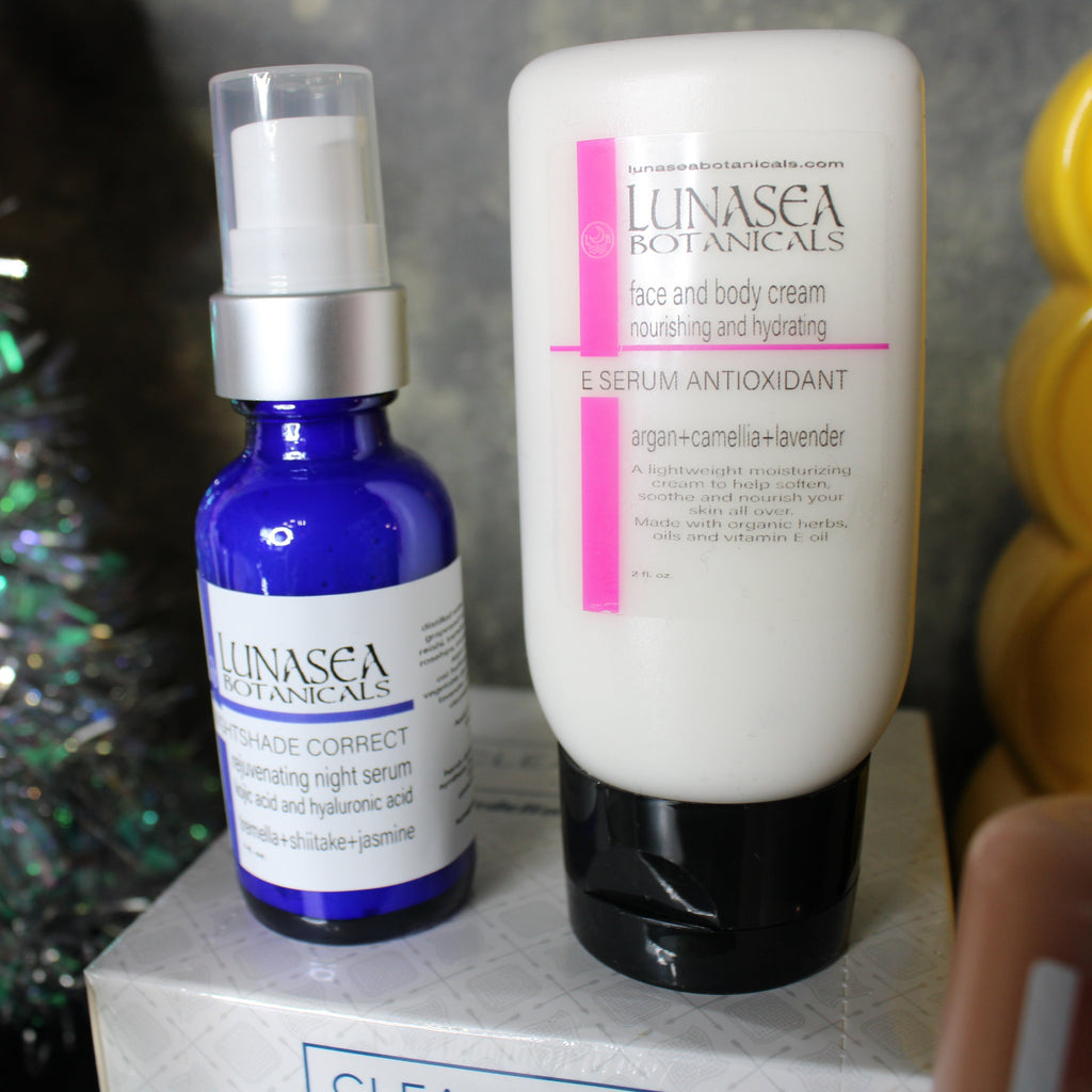 Two skincare products from Lunasea Botanicals on a surface with a colorful background.