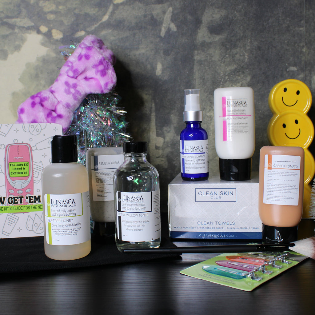 Collection of skincare products on a dark surface with a decorative background