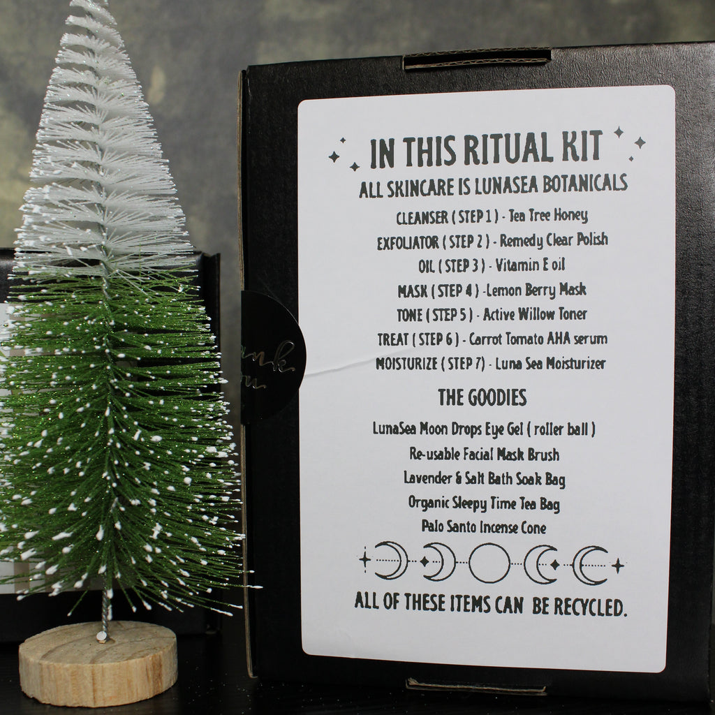 Product packaging with a label and decorative tree on a dark surface