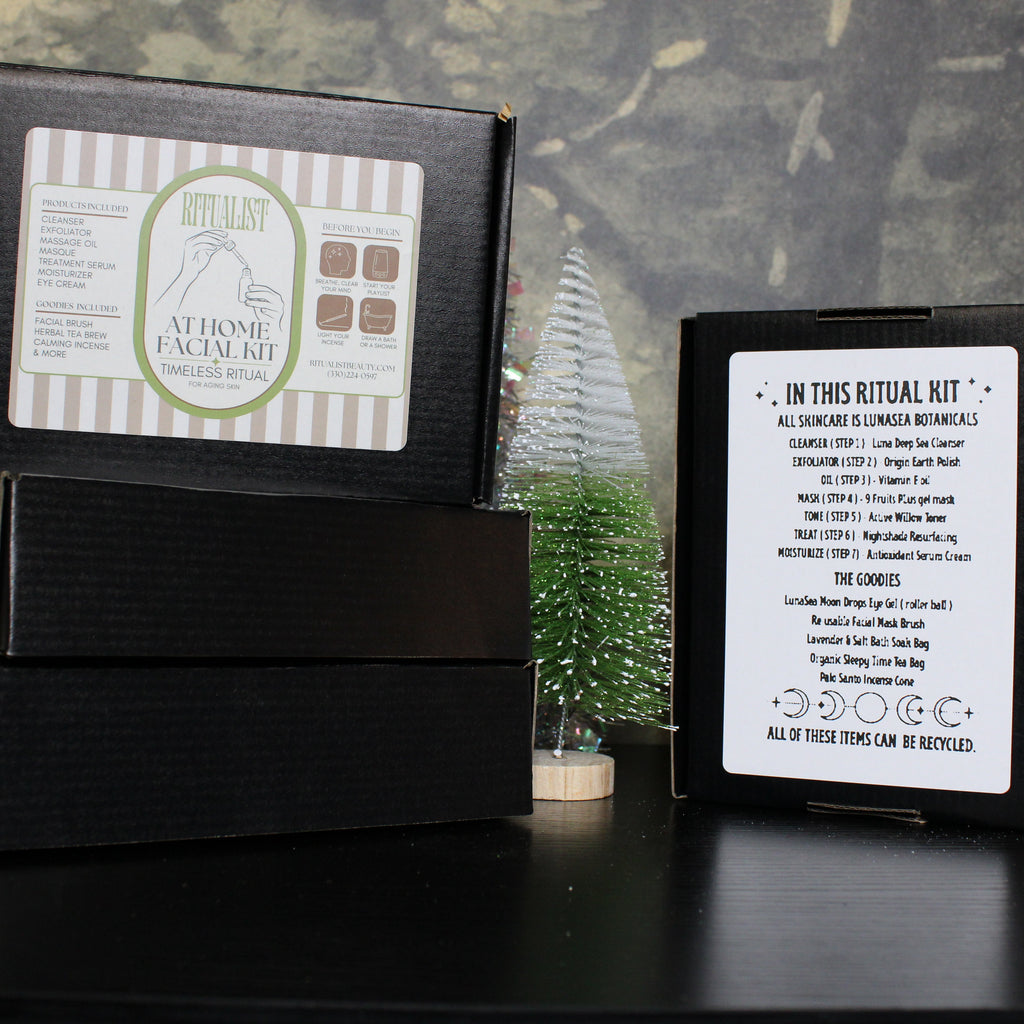 Black boxes with labels on a dark surface against a greenery background